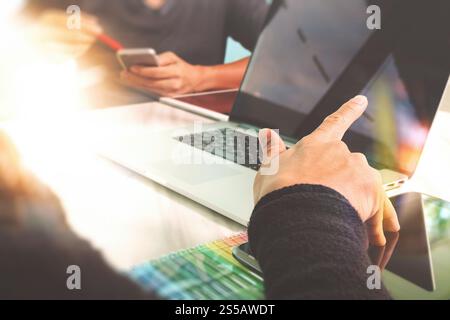 Photo website graphic designer hand working with new project modern studio.Modern laptop digital tablet smart phone on wood table.Books papers Stock Photo
