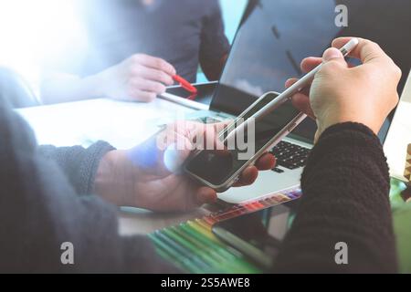 Photo website graphic designer hand working with new project modern studio.Modern laptop digital tablet smart phone on wood table.Books papers Stock Photo