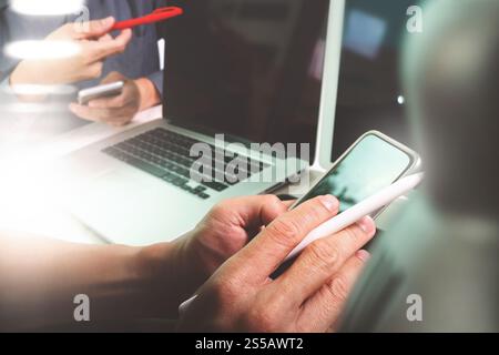 Photo website graphic designer hand working with his team make new project in studio.Modern laptop extend screen digital tablet smart phone on marble Stock Photo