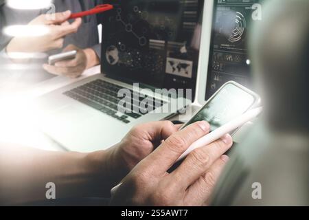 Photo website graphic designer hand working with his team make new project in studio.Modern laptop extend screen digital tablet smart phone on marble Stock Photo