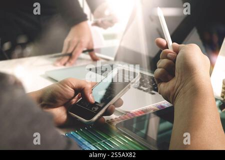 Photo website graphic designer hand working with new project modern studio.Modern laptop digital tablet smart phone on wood table.Books papers Stock Photo
