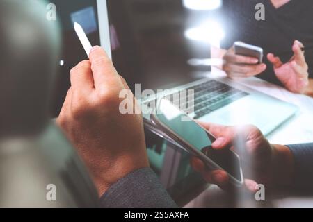 Photo website graphic designer hand working with his team make new project in studio.Modern laptop extend screen digital tablet smart phone on marble Stock Photo
