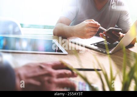 Photo website graphic designer hand meeting team with new project modern studio.Modern laptop digital tablet smart phone on marble table.pan-tone Stock Photo