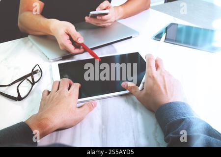 Photo website graphic designer hand working with his team make new project in studio.Modern laptop extend screen digital tablet smart phone on marble Stock Photo