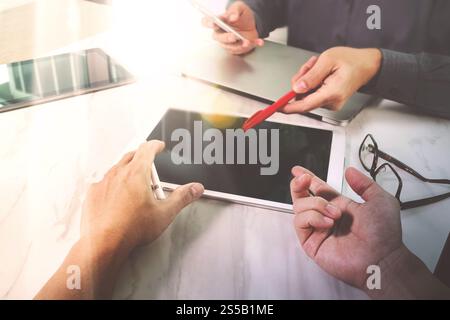 Photo website graphic designer hand working with his team make new project in studio.Modern laptop extend screen digital tablet smart phone on marble Stock Photo