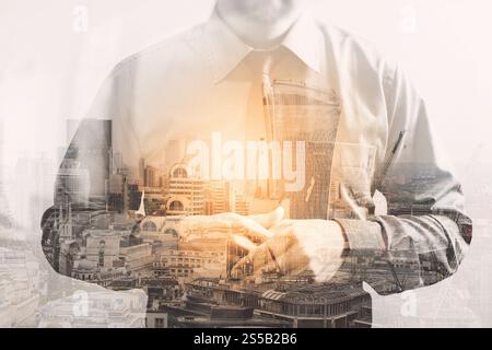 Double exposure of success businessman holding his hand with London building,front view,filter effect Stock Photo