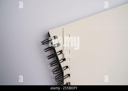 Opend blank notebook with white cover with spiral bound on white background. Business or education concept Stock Photo
