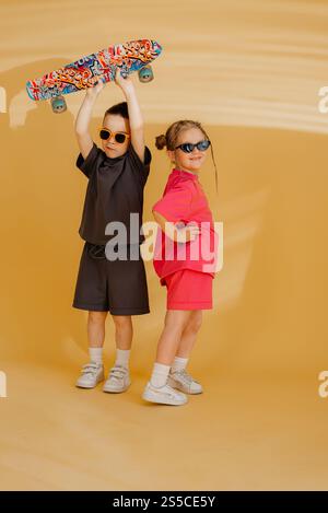 Little couple kids boy girl 4-5 years old clothes shirt dress posing have fun isolated on white background children studio portrait. People childhood Stock Photo