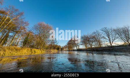 Frozen swimming pond in winter, York. UK Stock Photo