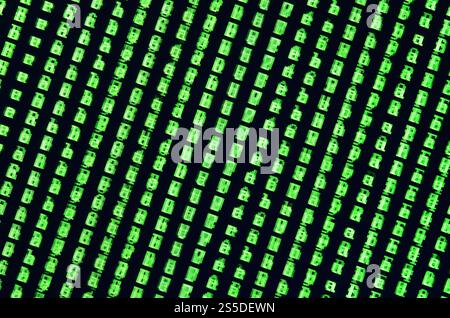Macro shot of a glitch on the monitor of an office computer. The concept of introducing a virus into a personal data keeper. Stream of random green Stock Photo