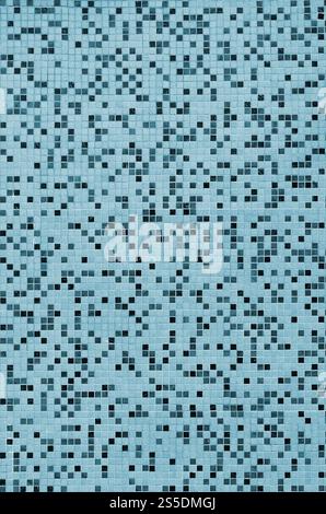 The texture of the wall, decorated with a mosaic of various small square tiles. Abstract pattern of ceramic tiles on the wall Stock Photo