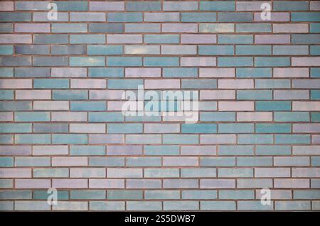The texture of wall from a variety of old and dirty brick. Detailed pattern of a plurality of different sizes of brick colored worn out. Colored Stock Photo