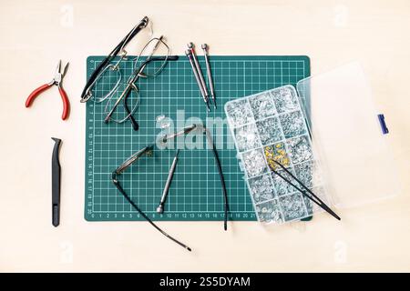 top view of kit for repairing used eyeglasses on wooden table Stock Photo