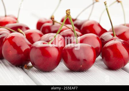 red cherry on white wood background Stock Photo