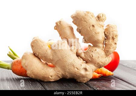 ginger on black wood background on white Stock Photo