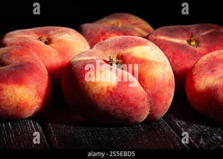 flat peach on black wood background Stock Photo