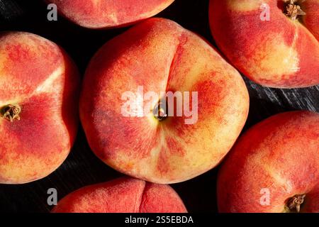 flat peach on black wood background top view Stock Photo