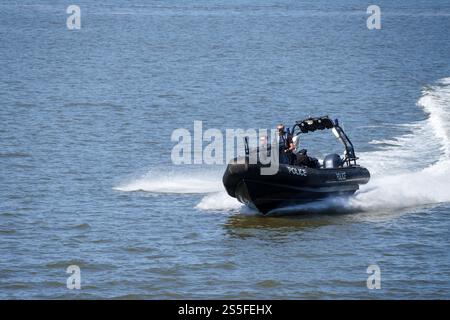 Police patrolling the River Mersey on a rigid inflatable boat Stock Photo