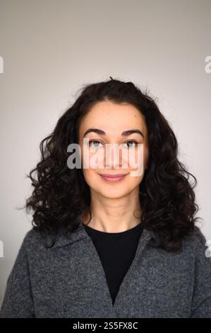 An isolated woman's portrait looking straight forward and smiling Stock Photo