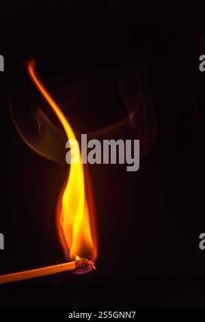 burning match on a dark background Stock Photo