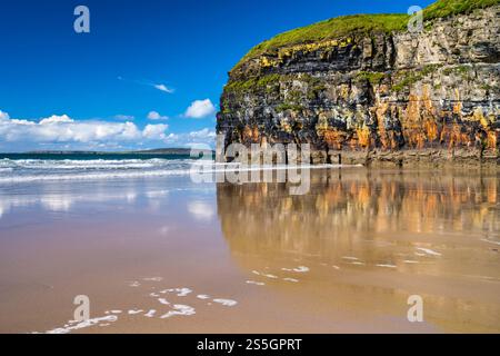 Picturesque cliff reflecting in wet sand at Ballybunion Beach, County Kerry, Ireland. One of the discovery points on Wild Atlantic Way. Stock Photo