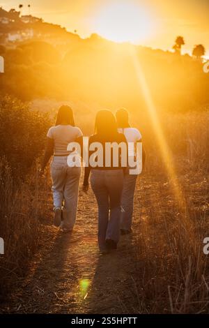 3 sisters hiking together during the sunset in Palos Verdes, CA Stock Photo