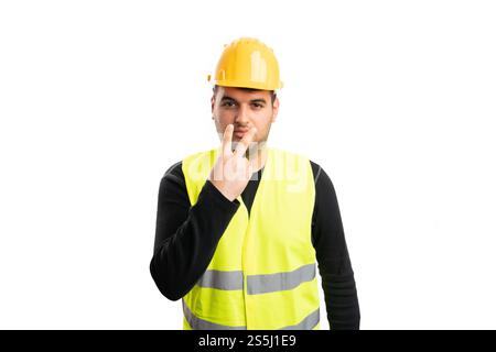 Adult male builder supervisor wearing vest and hardhat pointing fingers as eye contact gesture isolated on white studio background Stock Photo