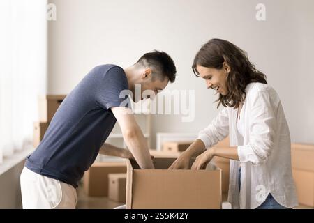 Young couple unpack their belongings stacked in boxes Stock Photo