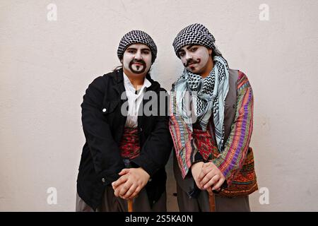 Diyarbakir, Turkey. 14th Jan, 2025. Two Kurdish girls seen with their face painting and dressed in men's clothes according to tradition, during Kurdish New Year festivities in Diyarbakir. Kurds living in Turkey, Iran, Iraq and Syria celebrated the traditional Kurdish New Year with festivities and concerts. On the Kurdish New Year's Eve, which is celebrated every year on the night of 13-14 January, men paint their faces, dress in women's clothes and go around the houses to receive gifts. (Photo by Mehmet Masum Suer/SOPA Images/Sipa USA) Credit: Sipa USA/Alamy Live News Stock Photo