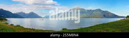Lake Como (Italy) summer cloudy view with snow on mount top . Stock Photo