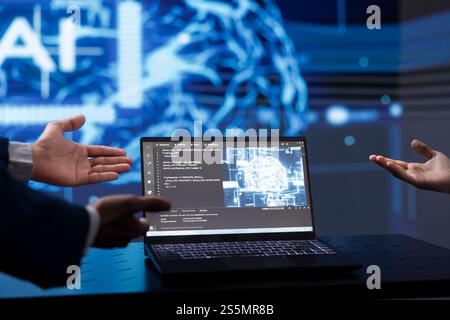 Computer scientists use AI cognitive computing to extract information from complex data on laptop. Close up of IT specialists using artificial intelligence technology on notebook Stock Photo