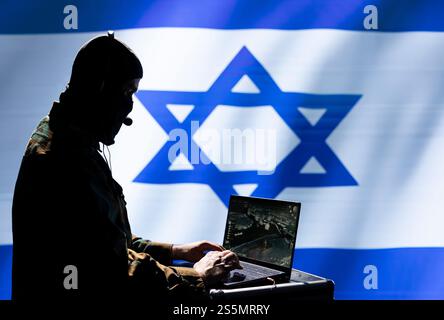 Israel Mossad agent working on laptop, analyzing aerial reconnaissance data to come up with war winning strategy. Secret service agent controlling drones attacking strategic targets Stock Photo