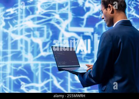 System administrator solving tasks on laptop, running artificial intelligence programming scripts. Technician manipulating lines of code for AI applications development on notebook Stock Photo