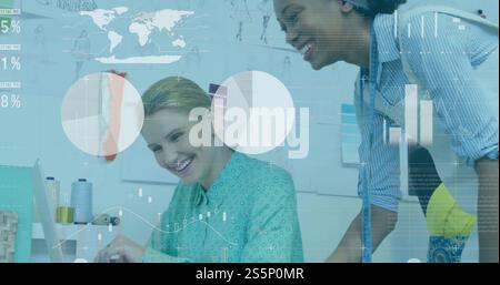 Image of charts processing data over diverse female designers discussing at computer Stock Photo