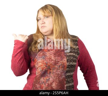 A middle-aged woman in a red patterned sweater points over her shoulder with a firm and assertive expression. Stock Photo