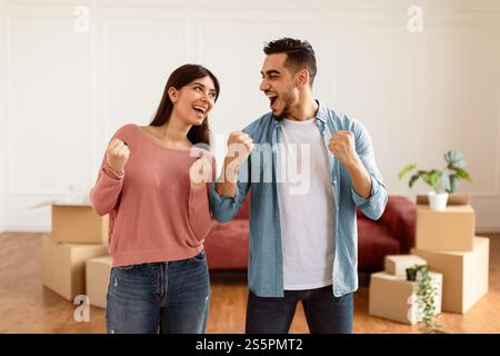 Happy man and woman celebrating moving day Stock Photo