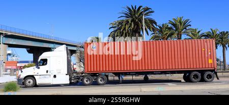 Freight Truck carrying a FLORENS shipping container on a street toward ...