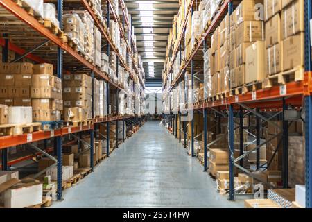 Interior view of an aisle of a distribution warehouse full of packages and no people Stock Photo