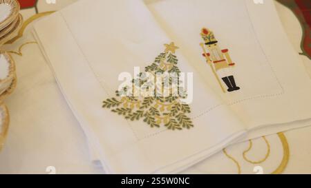 beautiful white cloth napkins with christmas decoration on christmas table for sharing. christmas celebration time concept Stock Photo