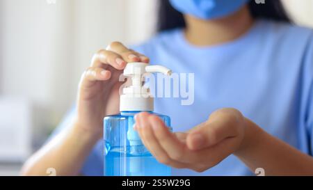 Hand applying Alcohol gel sanitazer liquid cleaning hands for prevent corona virus covid-19. woman hand sanitizer Alcohol gel gel for hand hygiene Stock Photo