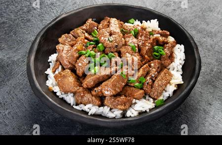 Bulgogi with meat on dark background. Traditional Korean food. Stock Photo