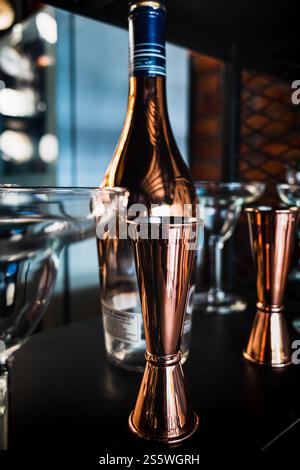Clean and Shiny Glasses and Bottle Displayed on the Shelf of a Bar Stock Photo