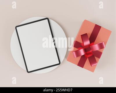 The tablet is placed on a white pedestal and has a gift box. Stock Photo