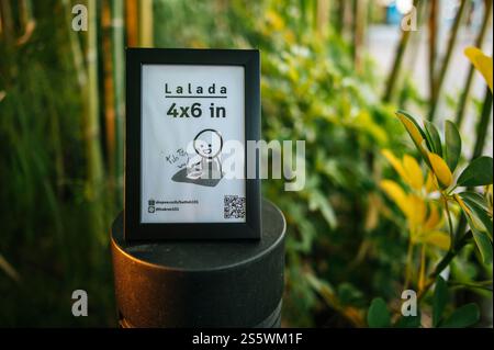 black frame promotion board on the lamp in garden Stock Photo