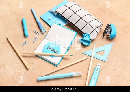Sticky note with word GOAL and stationery on grunge background Stock Photo
