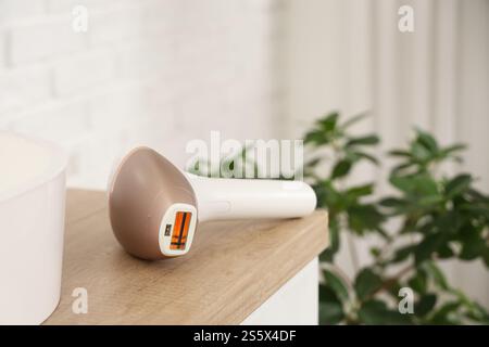 Modern photoepilator on table in bathroom, closeup Stock Photo