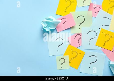 Different sticky notes with question marks on color background Stock Photo