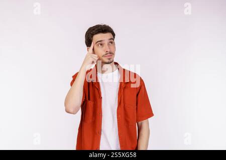 Portrait of thinking man surrounded by question mark on isolated background. Finding inspiration or solution to problem. Stock Photo