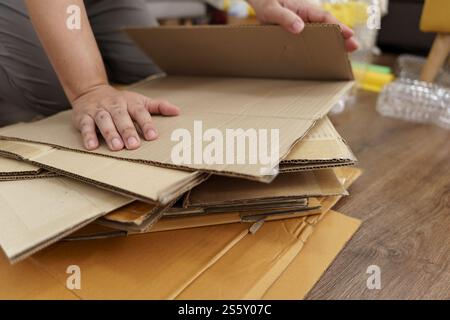 Home recycle eco zero waste concept Man using recycle paper box. Stacking brown cardboard box eco friendly packaging made of recyclable raw materials Stock Photo