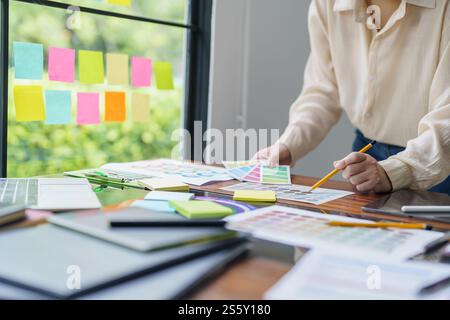 Creative idea Business female Artist Creative Designer sketch graphic drawing on graphic tablet and Color swatch samples Concept of idea creativity Stock Photo